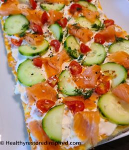 Everything Bread topped with cucumbers, smoked salmon and cherry tomatoes