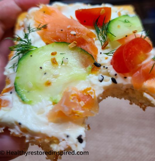 Low carb crust topped with dairy-free cream cheese, cucumbers and smoked salmon
